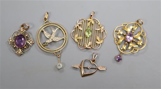 Five assorted early 20th century and later yellow metal and gem set pendants, including three 9ct.